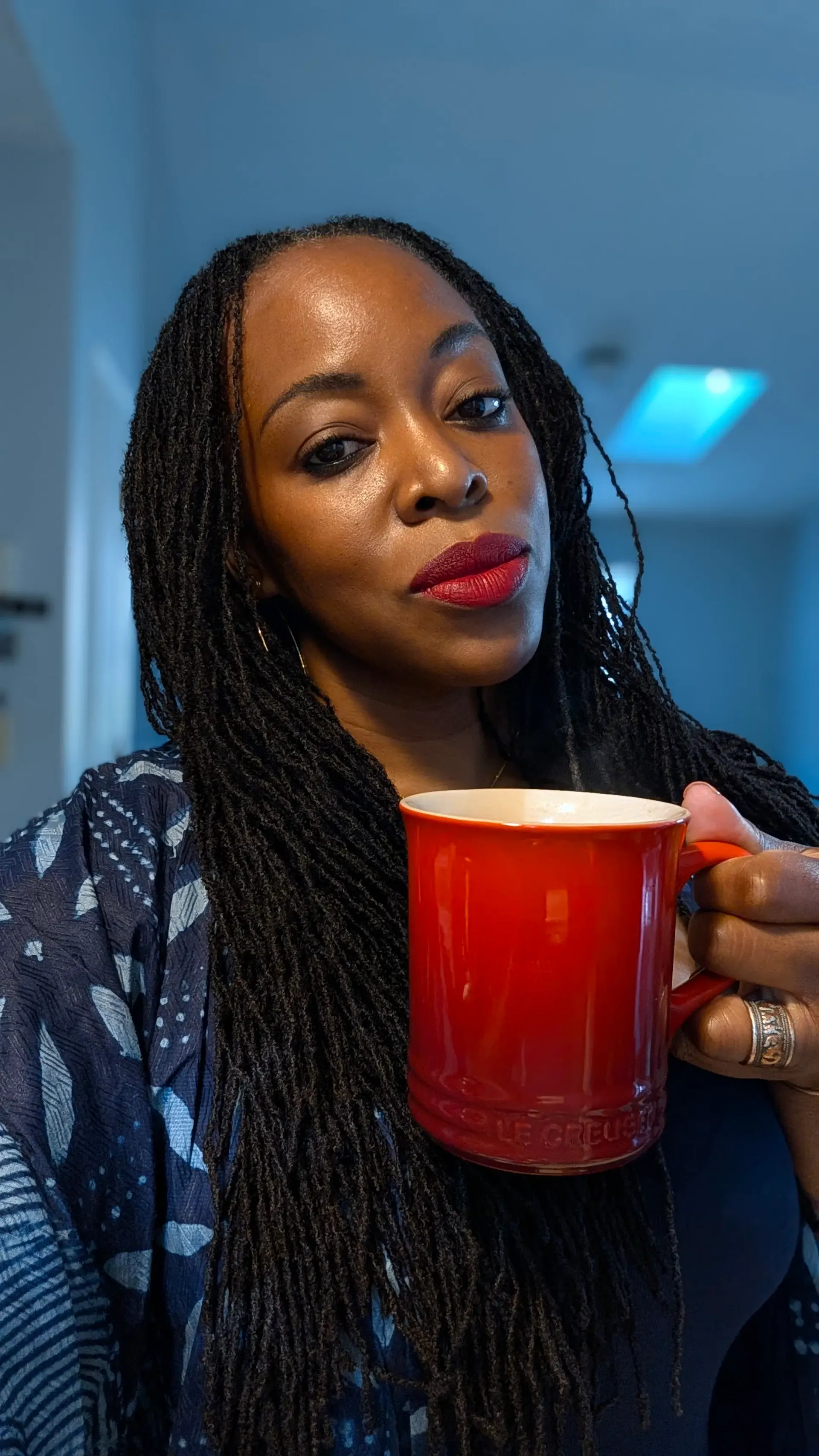 OlaBISI MacGregor holding a red mug